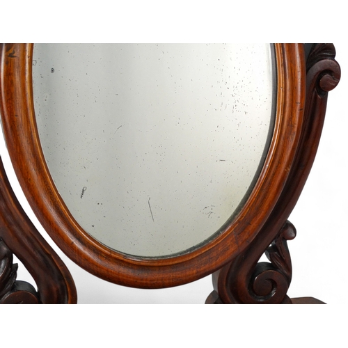 952 - A Victorian mahogany toilet mirror - with an oval plate between shaped supports on an ogee shaped ba... 