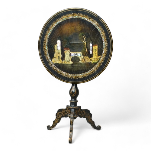 954 - A Victorian papier mache tilt top table - the circular top with lake scene within a mother-of-pearl ... 