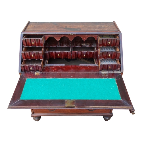 956 - A George III mahogany bureau bookcase - the upper section with shaped panel doors enclosing adjustab... 