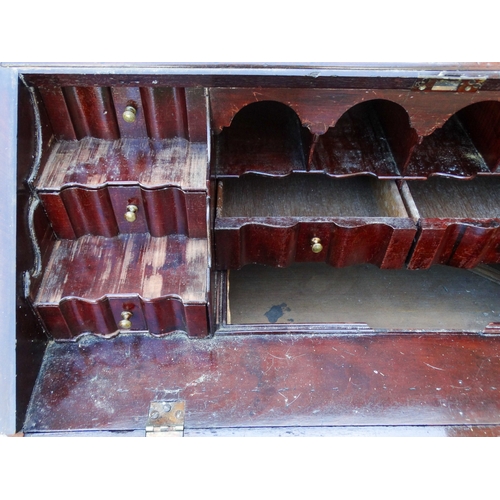 956 - A George III mahogany bureau bookcase - the upper section with shaped panel doors enclosing adjustab... 