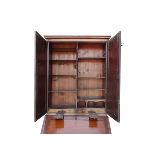 956 - A George III mahogany bureau bookcase - the upper section with shaped panel doors enclosing adjustab... 