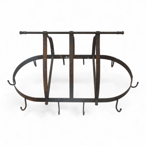 98 - A wrought iron oval kitchen rack - with ten hooks, height 47cm, width 89cm.