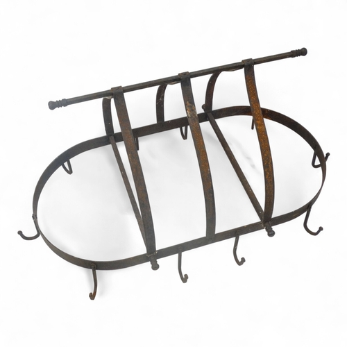 98 - A wrought iron oval kitchen rack - with ten hooks, height 47cm, width 89cm.