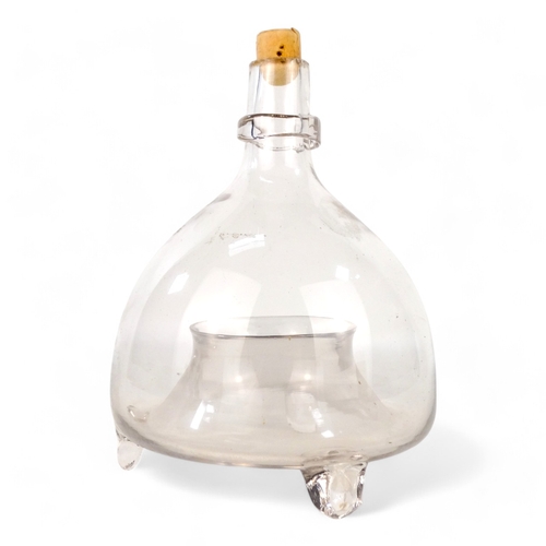 10 - A late Victorian clear glass fly trap - onion shaped and raised on three bracket feet, 18cm high.