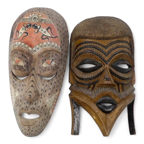 119 - A vintage African wall mask - natural polished wood with black details, 47cm high together with an p... 