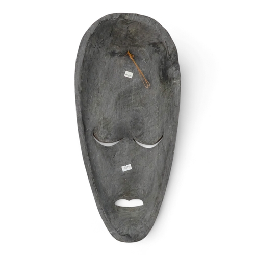 119 - A vintage African wall mask - natural polished wood with black details, 47cm high together with an p... 