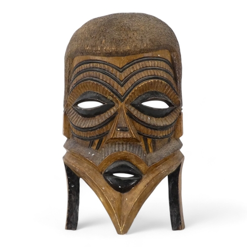 119 - A vintage African wall mask - natural polished wood with black details, 47cm high together with an p... 