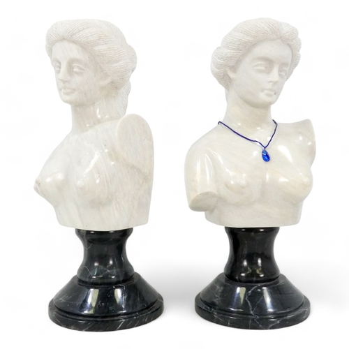 121 - A pair of 20th century carved white marble busts - Grecian style women, and raised on circular grey ... 