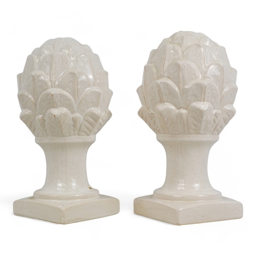 131 - A pair of white glazed ceramic artichokes - on square plinths, height 31cm.