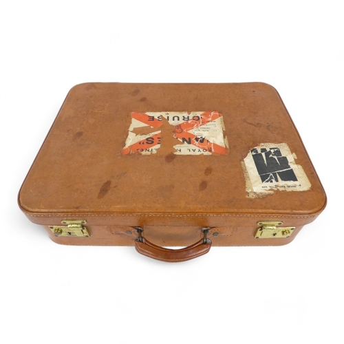 134 - A mid 20th century set of tan leather luggage - two large and one smaller, with brass catches and ta... 