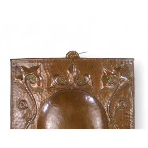 18 - A fine copper twin branch wall sconce by John Pearson - rectangular with foliate repousse decoration... 