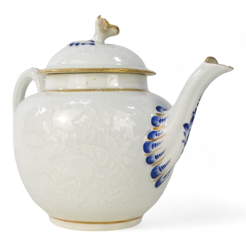 202 - A late 18th century bullet shaped teapot - with moulded floral and foliate decoration with blue and ... 