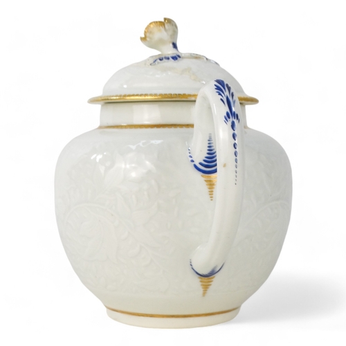 202 - A late 18th century bullet shaped teapot - with moulded floral and foliate decoration with blue and ... 