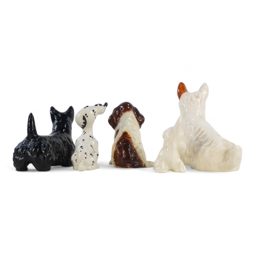 211 - A Beswick black Scottie dog - standing, together with another seated white example and three further... 