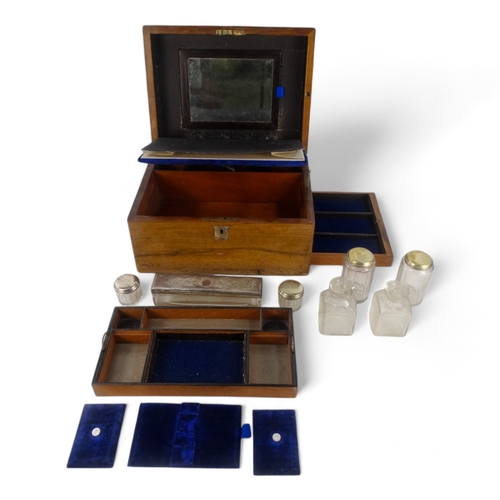 22 - A late Victorian walnut dressing case - the blue velvet fitted interior with glass and silverplated ... 