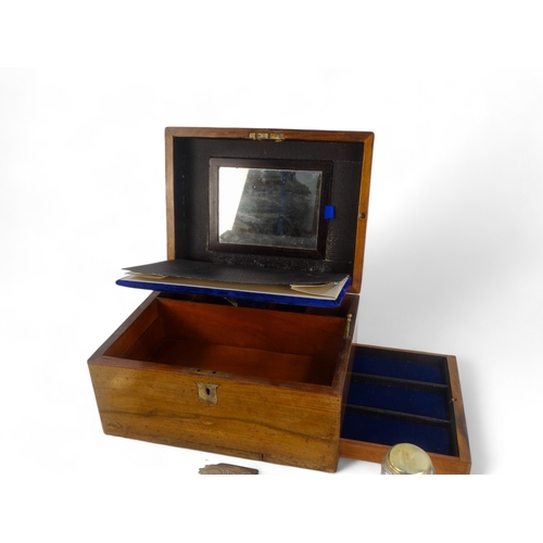 22 - A late Victorian walnut dressing case - the blue velvet fitted interior with glass and silverplated ... 