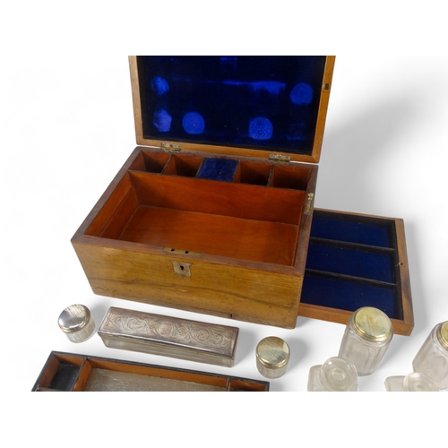 22 - A late Victorian walnut dressing case - the blue velvet fitted interior with glass and silverplated ... 