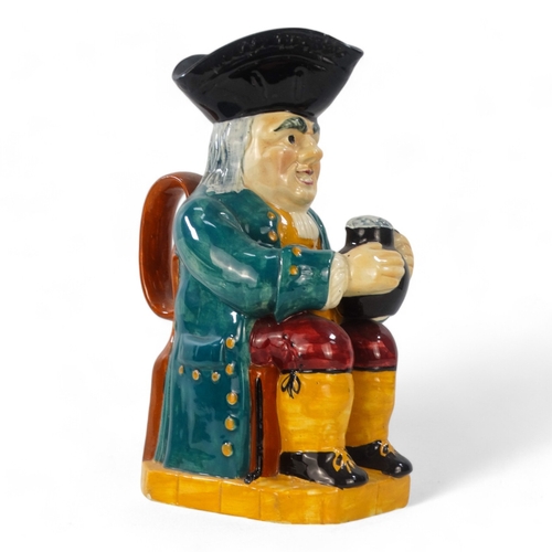 220 - An early 20th century Woods style Toby jug - wearing a green jacket and red breeches, 32cm high.