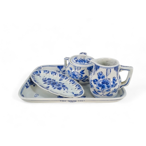 221 - A 20th century Delft part coffee service - comprising a rectangular tray, a small jug, a sucrier and... 