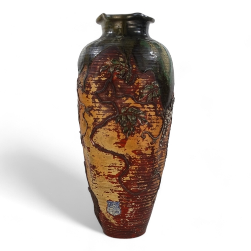 223 - A large early 20th century baluster shaped vase - with an oriental design in low relief and with gre... 