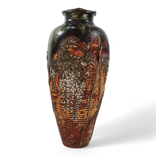 223 - A large early 20th century baluster shaped vase - with an oriental design in low relief and with gre... 