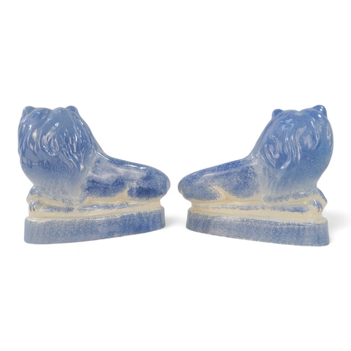 224 - A pair of Rye Pottery lions - recumbent, with a blue sponged finish, 18cm wide. (2)