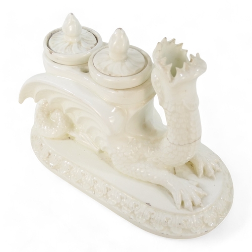 236 - A 19th century creamware ink stand - modelled as a dragon with twin lidded pots and raised on an ova... 