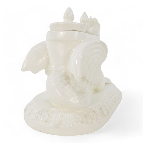 236 - A 19th century creamware ink stand - modelled as a dragon with twin lidded pots and raised on an ova... 