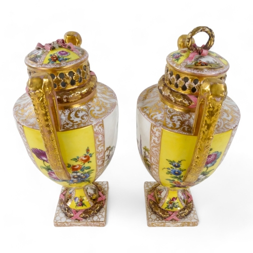 239 - A pair of Dresden vases - with reticulated covers and twin handles, painted with figures in a landsc... 