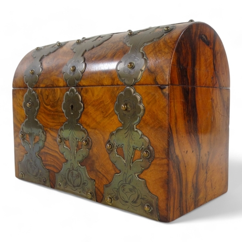 24 - A Victorian walnut stationery casket - with pierced and engraved brass mounts, 23cm wide.