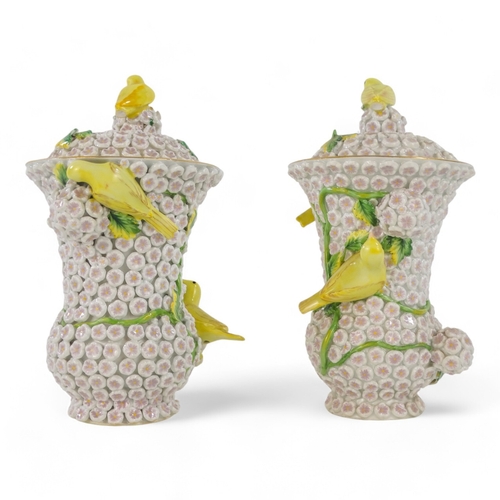 240 - A pair of Meissen style flower encrusted vases - of baluster form with yellow birds, 18cm high. (2)