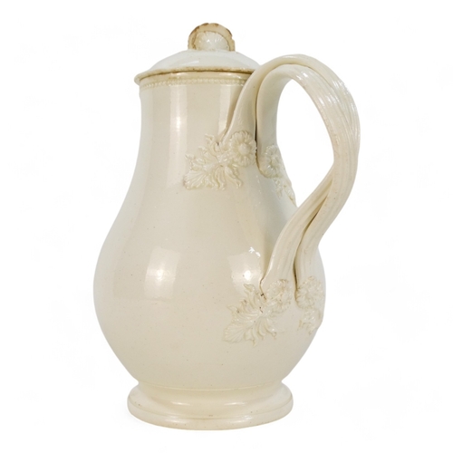 243 - A late 18th century creamware jug - of lidded baluster form, the wrythen handles with floral termina... 