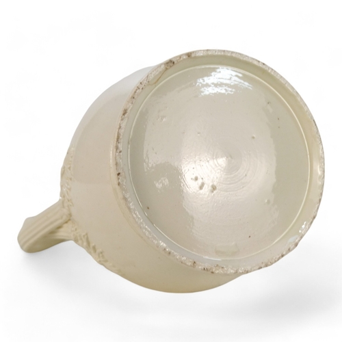 243 - A late 18th century creamware jug - of lidded baluster form, the wrythen handles with floral termina... 