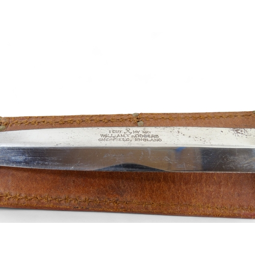 25 - A 20th century Bowie knife - Solingen Germany, with a walnut handle, within a brown leather scabbard... 