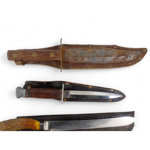 25 - A 20th century Bowie knife - Solingen Germany, with a walnut handle, within a brown leather scabbard... 