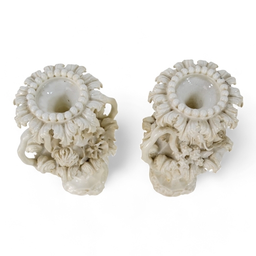 255 - A pair of late 19th century Blanc de chine vases - of fluted baluster form and encrusted with flower... 