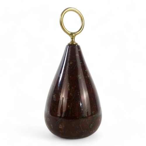 27 - A 20th century serpentine door stop - of tear-drop form with a brass ring handle, the base with a la... 