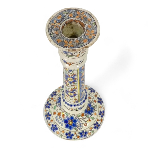 271 - A pair of early 20th century Iznik style candlesticks - decorated with trailing flowers on a cream g... 