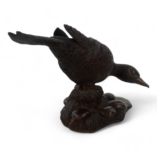 39 - A cold cast bronze model of a duck - signed M Jandy to base, 21cm wide.