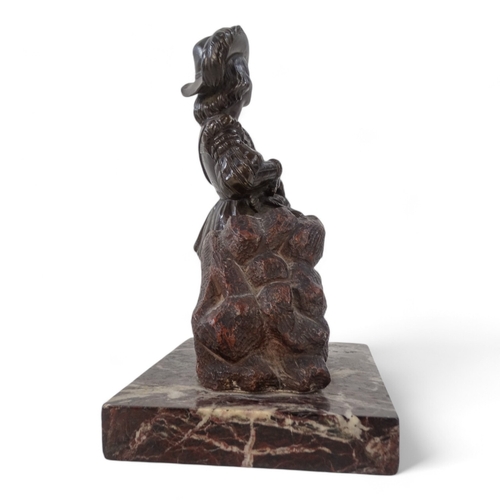 49 - A bronze modelled as a Dutch falconer - kneeling on a pile of rocks and mounted on a marble base, he... 