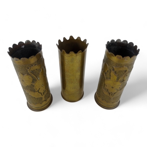 52 - Three WWI Trench Art shell cases - two with floral decoration and one inscribed 'Verdun 1916', heigh... 