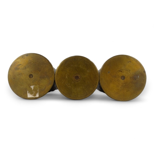 52 - Three WWI Trench Art shell cases - two with floral decoration and one inscribed 'Verdun 1916', heigh... 