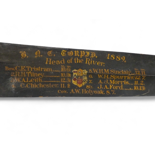 56 - A late 19th century 'Head of the River' oar blade - black painted, bearing crew names and weights, d... 