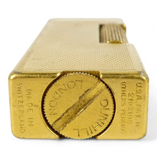 69 - A Dunhill gold plated cigarette lighter - of rectangular form and decorated with engine turning, tog... 