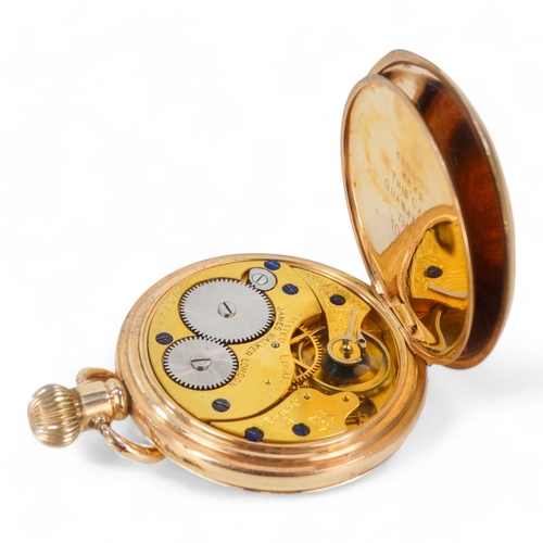 702 - A gold plated half hunter pocket watch by James Walker Ltd., - the white enamel dial set out with Ro... 