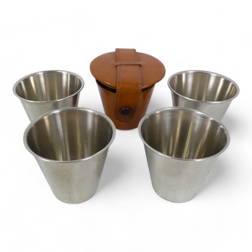 71 - A set of four stainless steel travel beakers - in a pig skin holder, together with five other groups... 