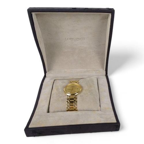 711 - A yellow metal gentleman' Longines wristwatch - probably 18ct gold, the gilt dial with baton markers... 