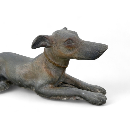 73 - An Art Deco spelter dog group - the pair of hounds raised on a polished marble base, 52cm wide.