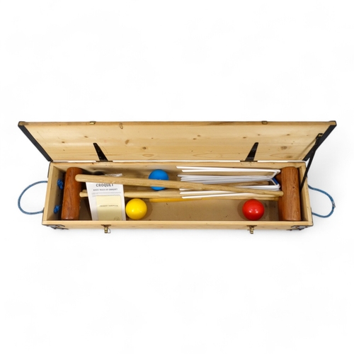 75 - A late 20th century garden croquet set - boxed, for four players with hoops, balls and centre peg.