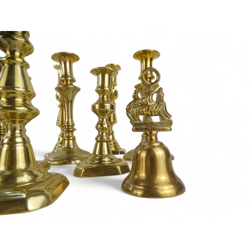 8 - Four 19th century brass candlesticks - of baluster form raised on circular bases, 23cm high, togethe... 